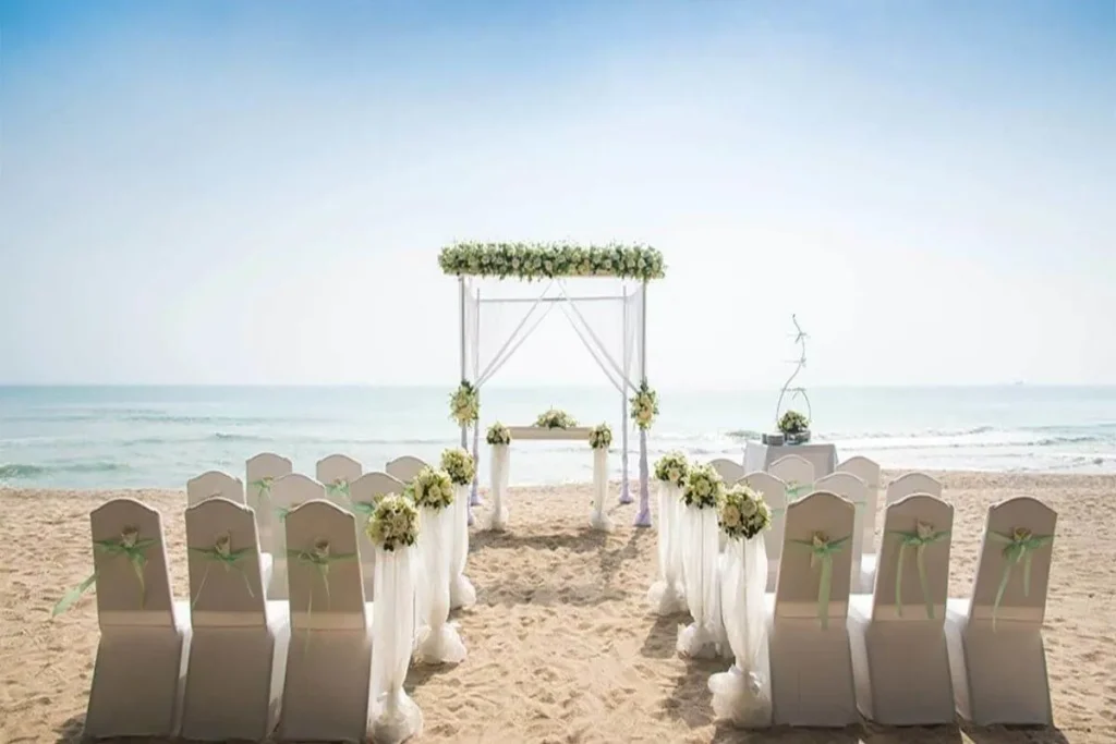 beach wedding ceremony with white decoration